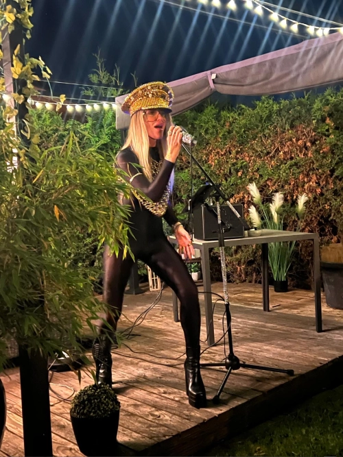 Danydeee singing on an outdoor stage at night
