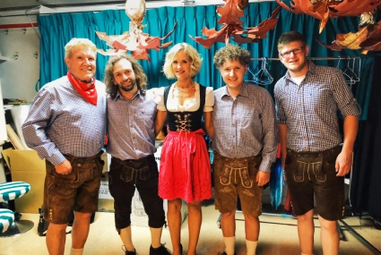 Group in traditional Bavarian costumes at an Oktoberfest-style event in Accra, Ghana