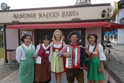 Band in Bavarian costumes with accordion outside a Bavarian restaurant in Nagoya, Japan